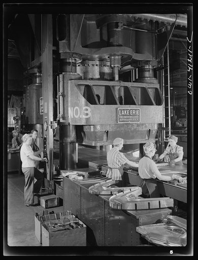 Untitled photo, possibly related to: Boeing aircraft plant, Seattle, Washington. Production of B-17 (Flying Fortress) bombing planes. Kirksite dies for the forming of parts of the B-17 (Flying Fortress). Bombers are being finished in a hydraulic press
