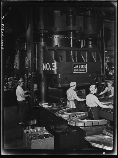 Untitled photo, possibly related to: Boeing aircraft plant, Seattle, Washington. Production of B-17 (Flying Fortress) bombing planes. Kirksite dies for the forming of parts of the B-17 (Flying Fortress). Bombers are being finished in a hydraulic press