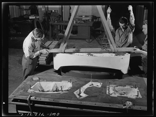 Untitled photo, possibly related to: Boeing aircraft plant, Seattle, Washington. Production of B-17 (Flying Fortress) bombing planes. Pouring a lead die to be used in the production of parts for B-17 (Flying Fortress) bombers