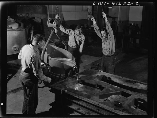 Untitled photo, possibly related to: Boeing aircraft plant, Seattle, Washington. Production of B-17 (Flying Fortress) bombing planes. Pouring a lead die to be used in the production of parts for B-17 (Flying Fortress) bombers
