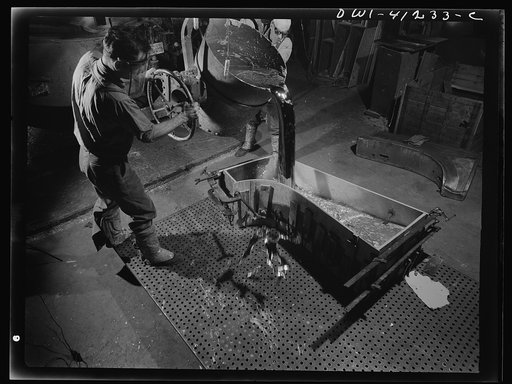 Boeing aircraft plant, Seattle, Washington. Production of B-17 (Flying Fortress) bombing planes. Pouring a lead die to be used in the production of parts