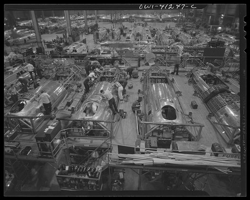Boeing aircraft plant, Seattle, Washington. Production of B-17 (Flying Fortress) bombing planes. Metal skins being applied to the roofs