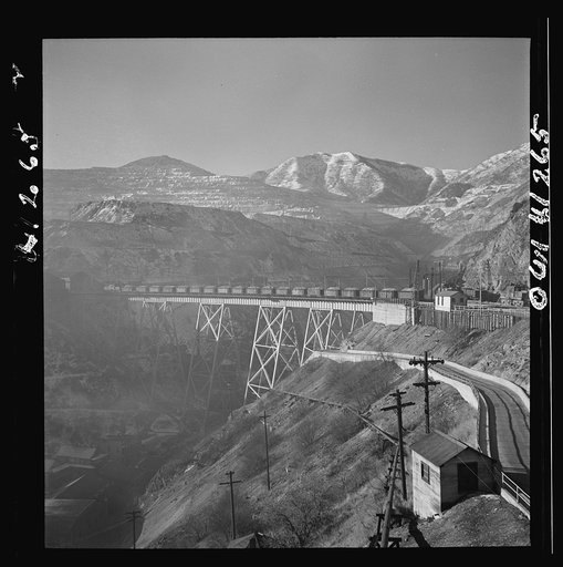 Untitled photo, possibly related to: Bingham Canyon, Utah. Open-pit workings of the Utah Copper Company, showing loaded ore trains in the foreground