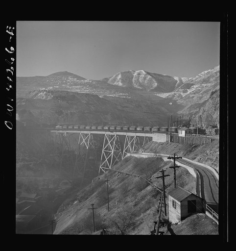 Untitled photo, possibly related to: Bingham Canyon, Utah. Open-pit workings of the Utah Copper Company, showing loaded ore trains in the foreground