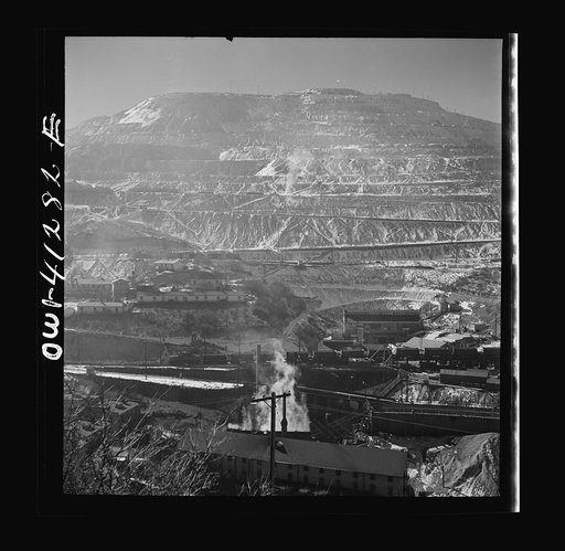Untitled photo, possibly related to: Bingham Canyon, Utah. Open-pit workings of the Utah Copper Company, showing loaded ore trains in the foreground