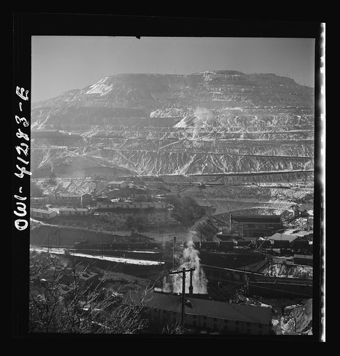 Untitled photo, possibly related to: Bingham Canyon, Utah. Open-pit workings of the Utah Copper Company, showing loaded ore trains in the foreground