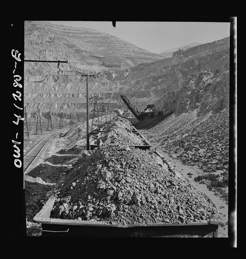 Untitled photo, possibly related to: Bingham Canyon, Utah. Looking over the tops of cars loaded with ore at an open-pit mine of the Utah Copper Company