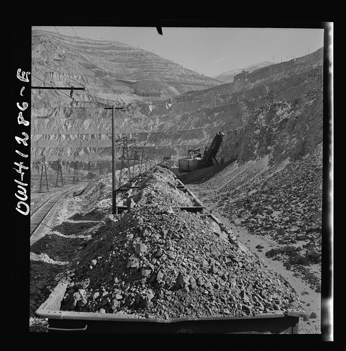 Untitled photo, possibly related to: Bingham Canyon, Utah. Looking over the tops of cars loaded with ore at an open-pit mine of the Utah Copper Company