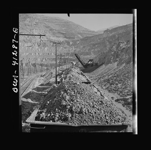 Bingham Canyon, Utah. Looking over the tops of cars loaded with ore at an open-pit mine of the Utah Copper Company