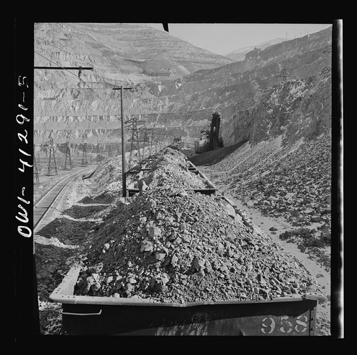 Untitled photo, possibly related to: Bingham Canyon, Utah. Looking over the tops of cars loaded with ore at an open-pit mine of the Utah Copper Company