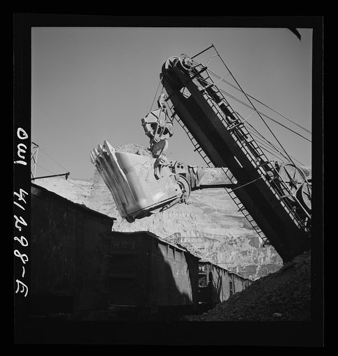 Untitled photo, possibly related to: Bingham Canyon, Utah. Huge dipper of a shovel loading ore into cars at a mine of the Utah Copper Company