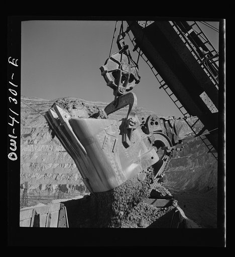 Untitled photo, possibly related to: Bingham Canyon, Utah. Huge dipper of a shovel loading ore into cars at a mine of the Utah Copper Company