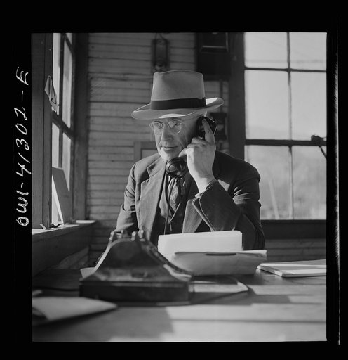Untitled photo, possibly related to: Bingham Canyon, Utah. Executives who keep heavy ore production coming from the open-pit mines of the Utah Copper Company looking out over the mine workings