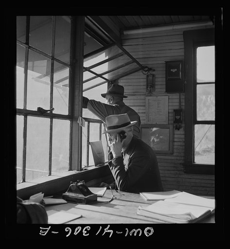 Untitled photo, possibly related to: Bingham Canyon, Utah. Executives who keep heavy ore production coming from the open-pit mines of the Utah Copper Company looking out over the mine workings