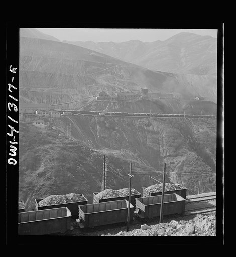 Untitled photo, possibly related to: Bingham Canyon, Utah. Open-pit workings on the Utah Copper Company showing cars loaded with ore