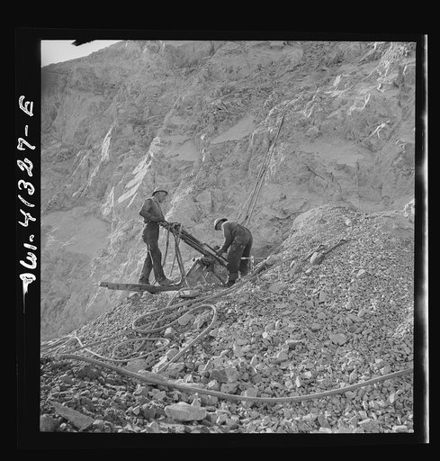 Bingham Canyon, Utah. Drilling blast holes with a rock-drill machine in an open-pit mine operated by the Utah Copper Company