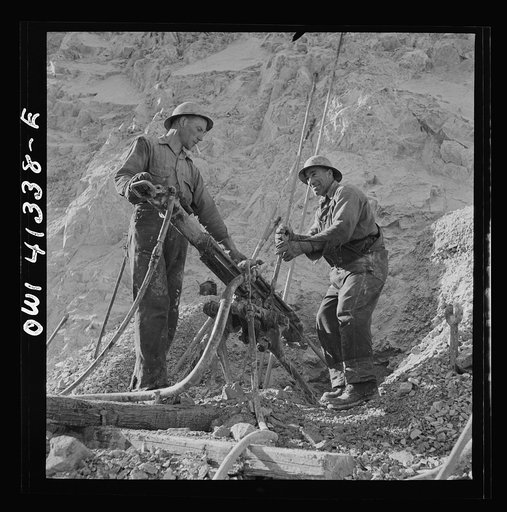 Untitled photo, possibly related to: Bingham Canyon, Utah. Drilling blast holes with a rock-drill machine in an open-pit mine operated by the Utah Copper Company