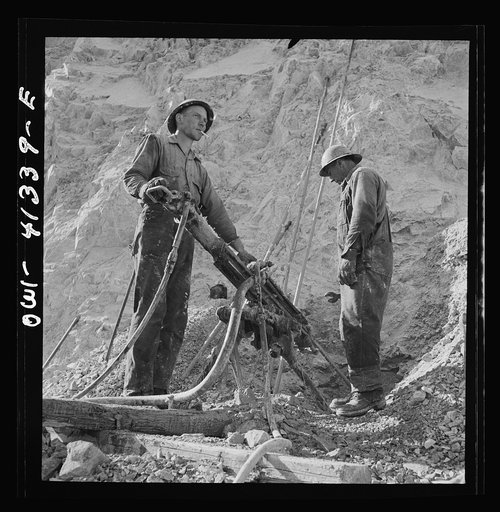 Untitled photo, possibly related to: Bingham Canyon, Utah. Drilling blast holes with a rock-drill machine in an open-pit mine operated by the Utah Copper Company