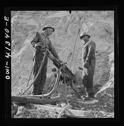 Untitled photo, possibly related to: Bingham Canyon, Utah. Drilling blast holes with a rock-drill machine in an open-pit mine operated by the Utah Copper Company