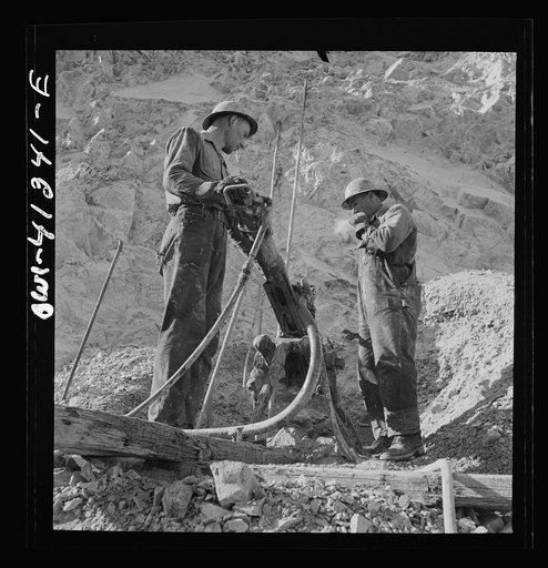 Untitled photo, possibly related to: Bingham Canyon, Utah. Drilling blast holes with a rock-drill machine in an open-pit mine operated by the Utah Copper Company