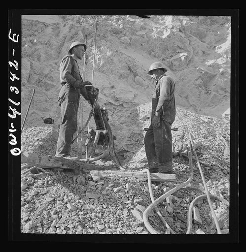 Untitled photo, possibly related to: Bingham Canyon, Utah. Drilling blast holes with a rock-drill machine in an open-pit mine operated by the Utah Copper Company