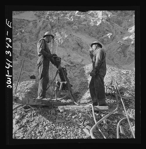 Untitled photo, possibly related to: Bingham Canyon, Utah. Drilling blast holes with a rock-drill machine in an open-pit mine operated by the Utah Copper Company