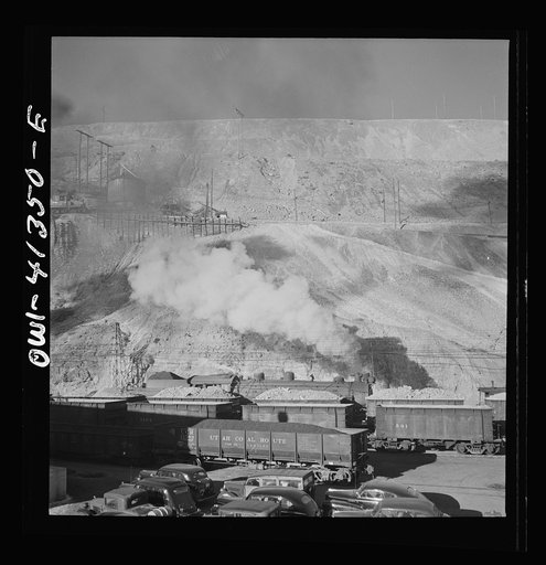 Bingham Canyon, Utah. Ore trains in a trestle bridge above an open pit mine of the Utah Copper Company
