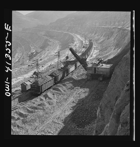 Untitled photo, possibly related to: Bingham Canyon, Utah. Loading ore into car with a power shovel at an open-pit mine of the Utah Copper Company