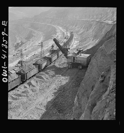 Untitled photo, possibly related to: Bingham Canyon, Utah. Loading ore into car with a power shovel at an open-pit mine of the Utah Copper Company