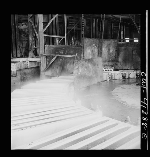 Untitled photo, possibly related to: Phelps Dodge refining company, El Paso, Texas. Sheets of pure copper, which had been formed by electrolysis in huge tanks, being melted now and cast into ingots