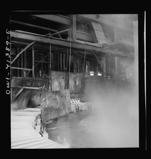 Untitled photo, possibly related to: Phelps Dodge refining company, El Paso, Texas. Sheets of pure copper, which had been formed by electrolysis in huge tanks, being melted now and cast into ingots