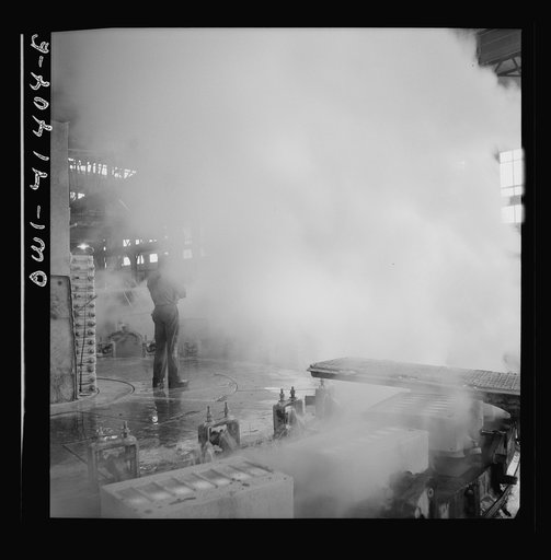 Untitled photo, possibly related to: Phelps Dodge refining company, El Paso, Texas. Sheets of pure copper, which had been formed by electrolysis in huge tanks, being melted now and cast into ingots