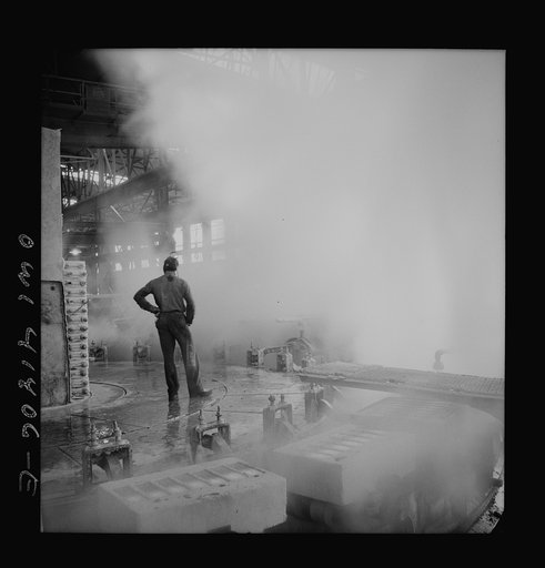 Untitled photo, possibly related to: Phelps Dodge refining company, El Paso, Texas. Sheets of pure copper, which had been formed by electrolysis in huge tanks, being melted now and cast into ingots