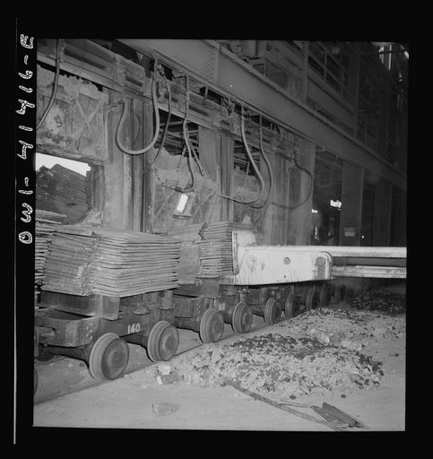 Untitled photo, possibly related to: Phelps Dodge refining company, El Paso, Texas. Charging sheets of copper, produced by electrolysis, into a reverbatory furnace