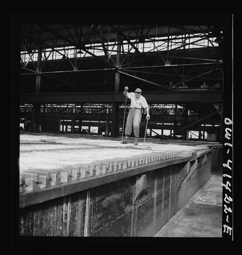 Untitled photo, possibly related to: El Paso, Texas. Phelps Dodge refinng company. Working at the electrolytic tanks in which sheets of pure copper are formed
