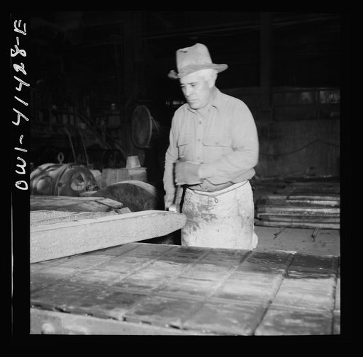 Untitled photo, possibly related to: El Paso, Texas. Workman trimming an ingot at the Phelps Dodge refining plant