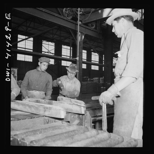 Untitled photo, possibly related to: El Paso, Texas. Workman trimming an ingot at the Phelps Dodge refining plant
