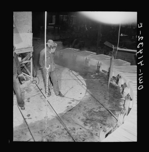 Untitled photo, possibly related to: Phelps Dodge refining company, El Paso, Texas. Sheets of pure copper, which had been formed by electrolysis in huge tanks, being melted now and cast into ingots