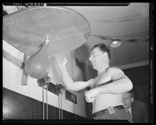 New York, New York. Joe Bruno, who is blind, giving a punching-bag a workout at the Lighthouse, an institution for the blind, at 111 East Fifty-ninth Street