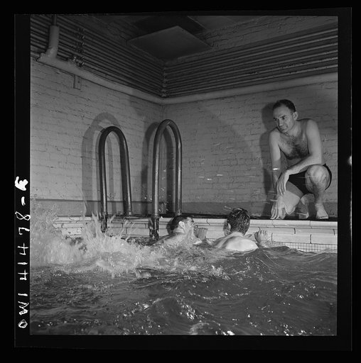 New York, New York. Irving Haeinowits, swimming instructor, giving instructions to two men in the pool at the Lighthouse, an institution for the blind, at 111 East Fifty-ninth Street