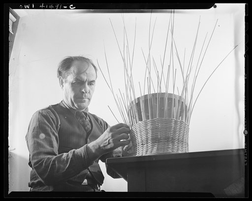 New York, New York. Alex Machginsky weaving a waste paper basket at the Lighthouse, an institution for the blind, at 111 East Fifty-ninth Street