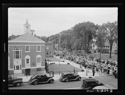 Untitled photo, possibly related to: Southington, Connecticut. An American town and its way of life. The Memorial Day parade moving down the main street. The small number of spectators is accounted for by the fact that the town's war factories did not close