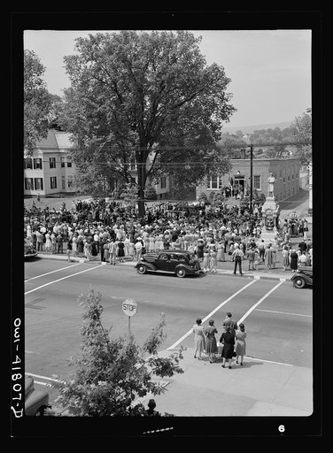 Untitled photo, possibly related to: Southington, Connecticut. An American town and its way of life. The Memorial Day parade moving down the main street. The small number of spectators is accounted for by the fact that the town's war factories did not close