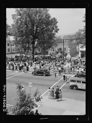 Untitled photo, possibly related to: Southington, Connecticut. An American town and its way of life. The Memorial Day parade moving down the main street. The small number of spectators is accounted for by the fact that the town's war factories did not close