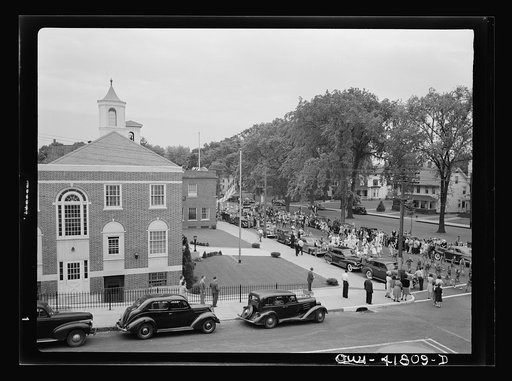 Untitled photo, possibly related to: Southington, Connecticut. An American town and its way of life. The Memorial Day parade moving down the main street. The small number of spectators is accounted for by the fact that the town's war factories did not close