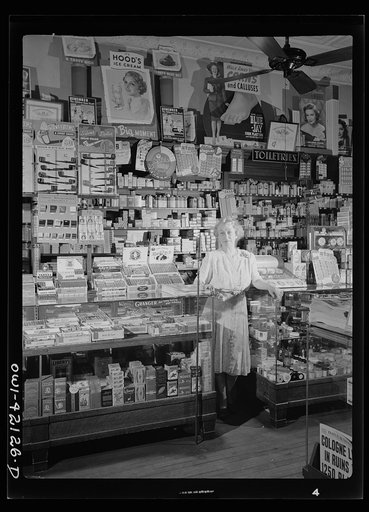 Southington, Connecticut. Mrs. Ethel Oxley, in the drugstore which she runs on the town's main street. Her family has had a business on this same corner for more than 200 years