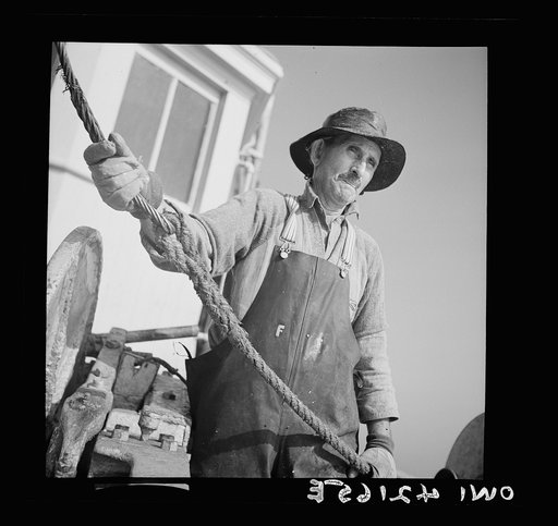 On board a fishing vessel out from Gloucester, Massachusetts. One of the fishing crew