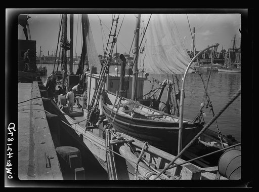 Gloucester, Massachusetts. A dragger alongside a wharf