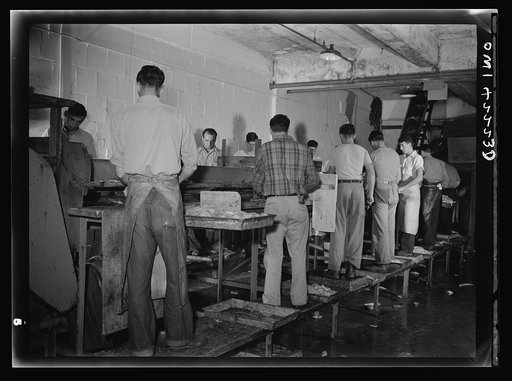 Gloucester, Massachusetts. Men at work on the fillet line in a fishing packing plant