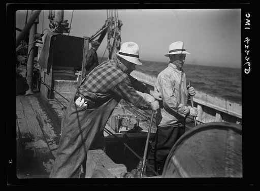 Gloucester, Massachusetts. Two Gloucester fishermen on a fishing boat